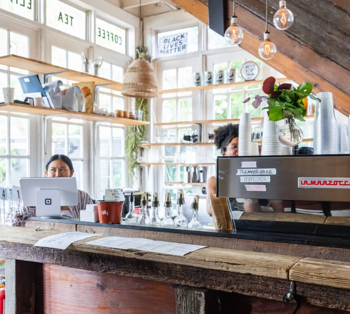 A woman sitting at the counter of a restaurant.