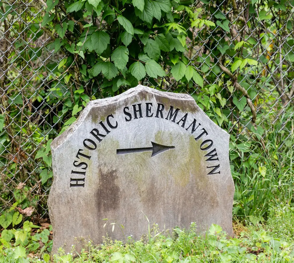 A stone sign with the words historic shermantown written on it.